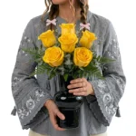 Arranjo de rosas amarelas em vaso preto moderno com folhagens verdes, elegante e sofisticado